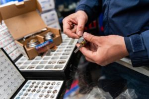 hands holding lock with a box of locks